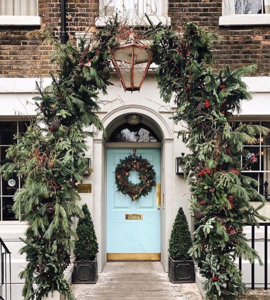 Green garland arch with blue door