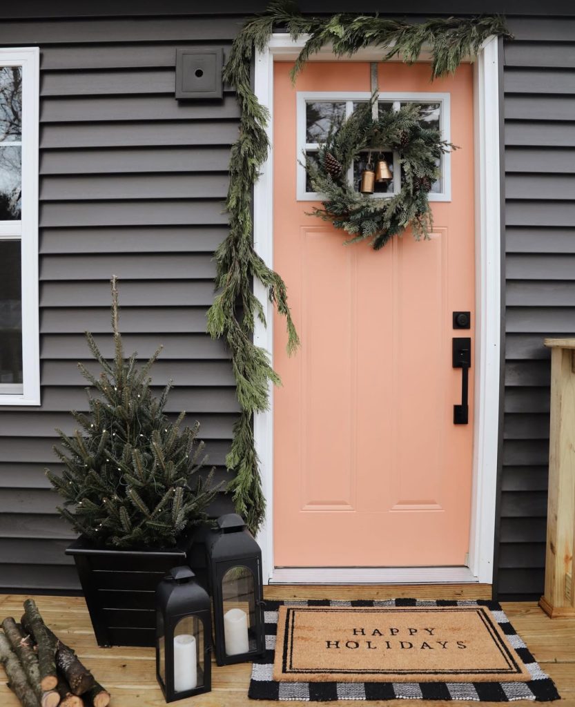 Peach door with Christmas wreath and garland