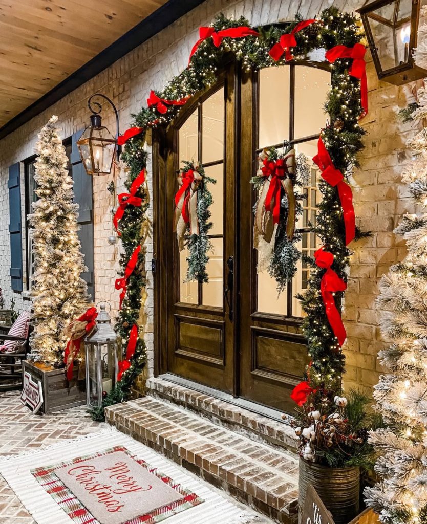 Double door Christmas porch with red ribbons