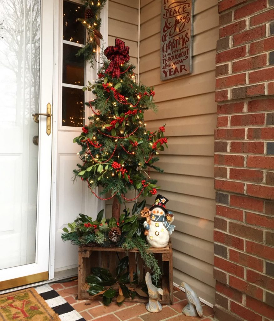 Rustic porch with vintage snowman and mini tree