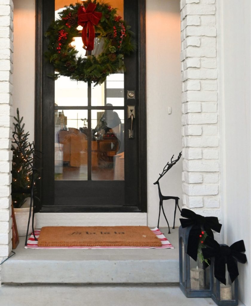 Minimalist black door with Christmas wreath