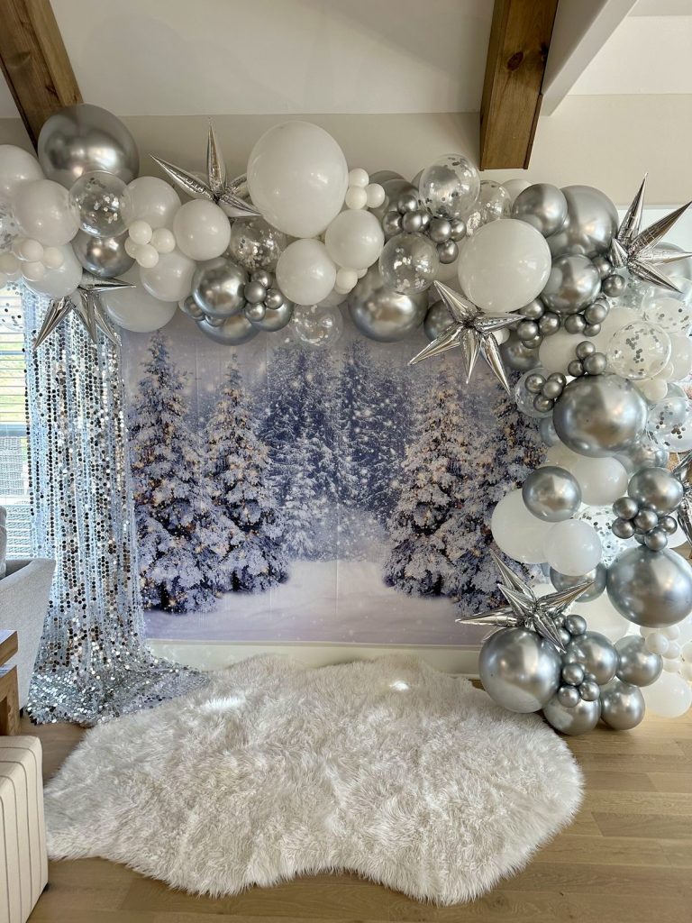 Silver balloon arch with winter backdrop