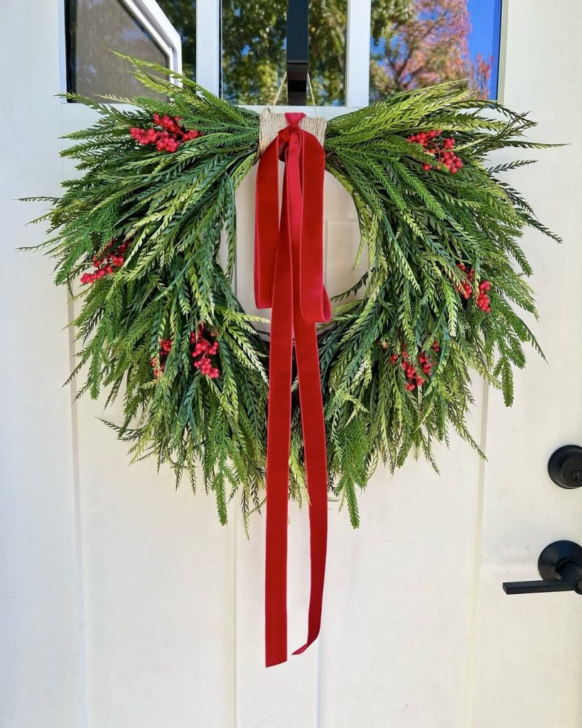 Wreath with red ribbon and berries