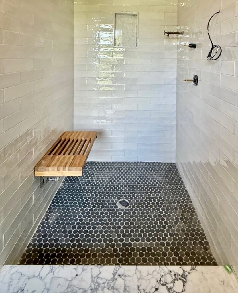 Black and White Shower Tiles with Wood Seat