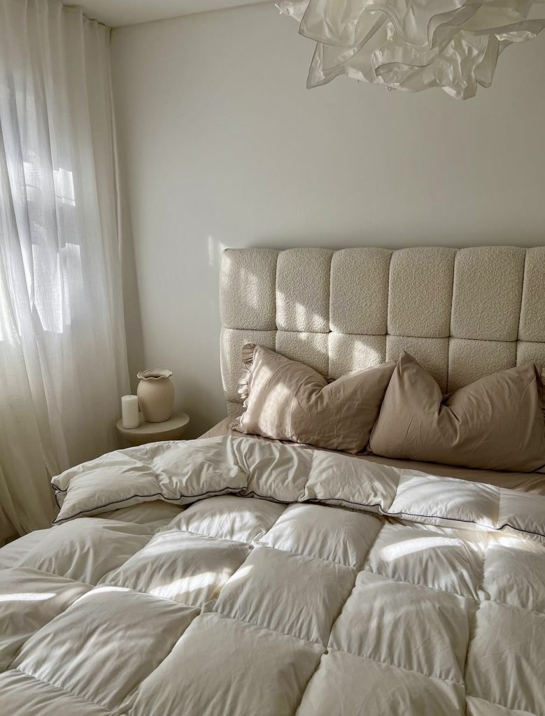Sunlit bedroom with white accents
