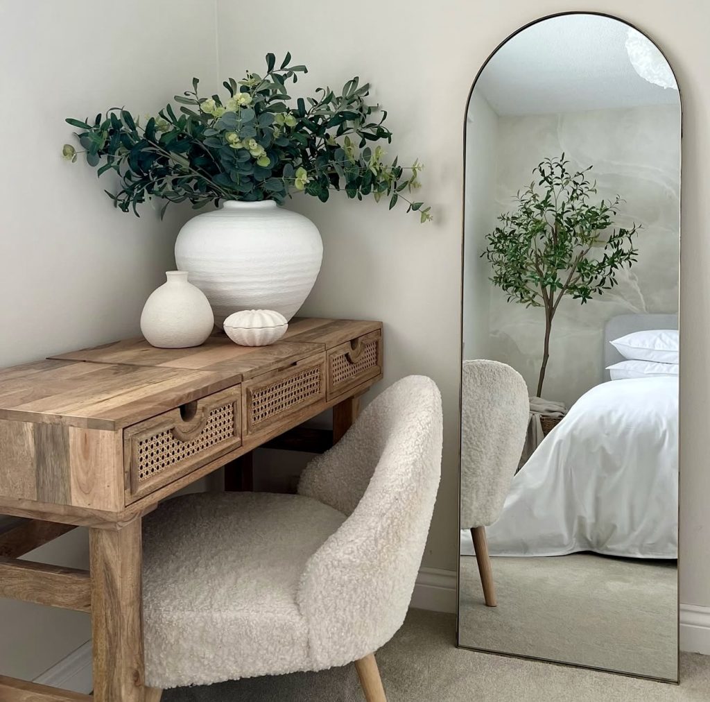 Bedroom corner with wooden desk and boucle chair