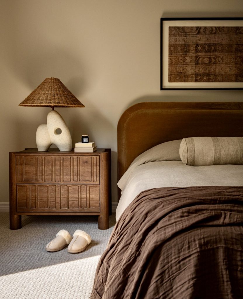 Bedroom with earthy tones and wooden nightstand
