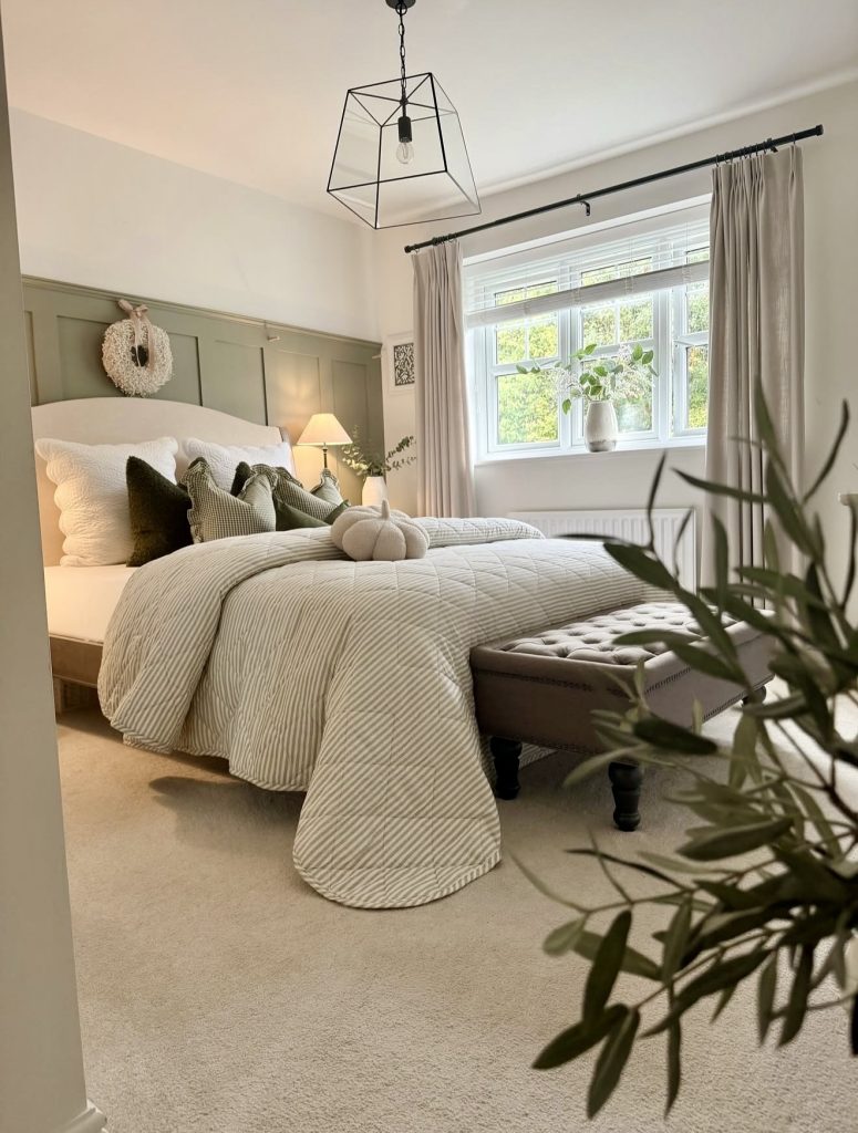 Bedroom with neutral tones and green accents