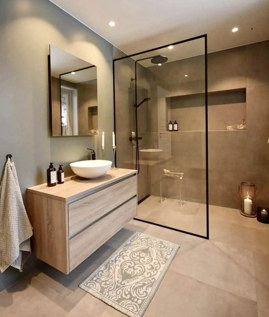 Neutral-toned walk-in shower with black framing