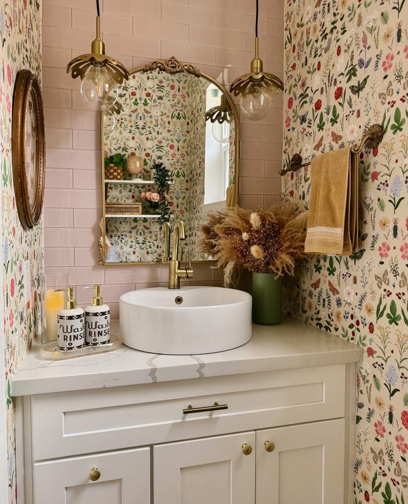 Powder room with floral wallpaper and gold accents