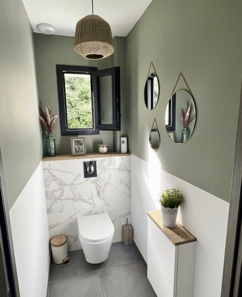 Small bathroom with green walls and rustic wood accents