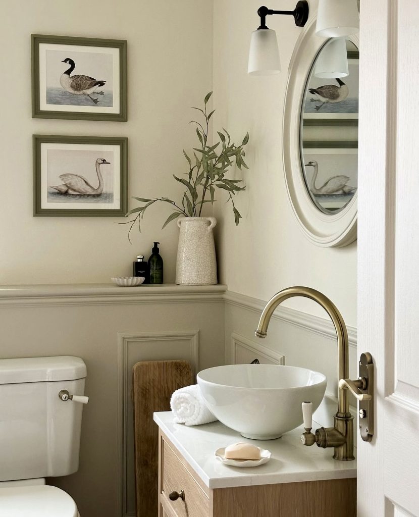 Guest bathroom with light walls and gold fixtures