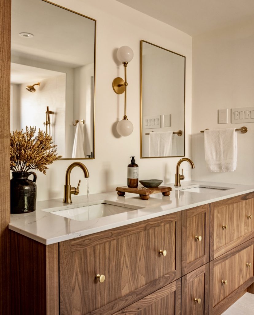 Bathroom with double vanity and gold accents