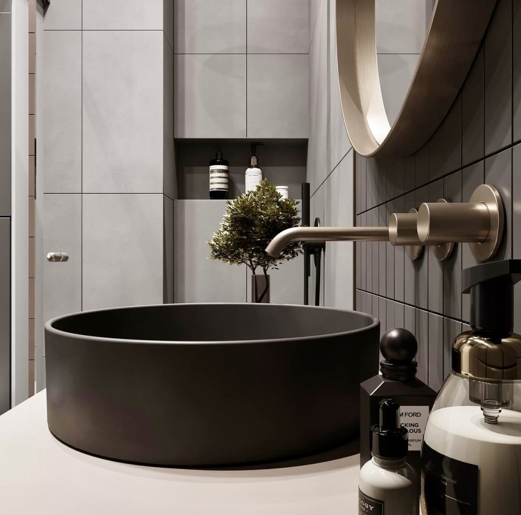 Bathroom with black sink and gray tiles