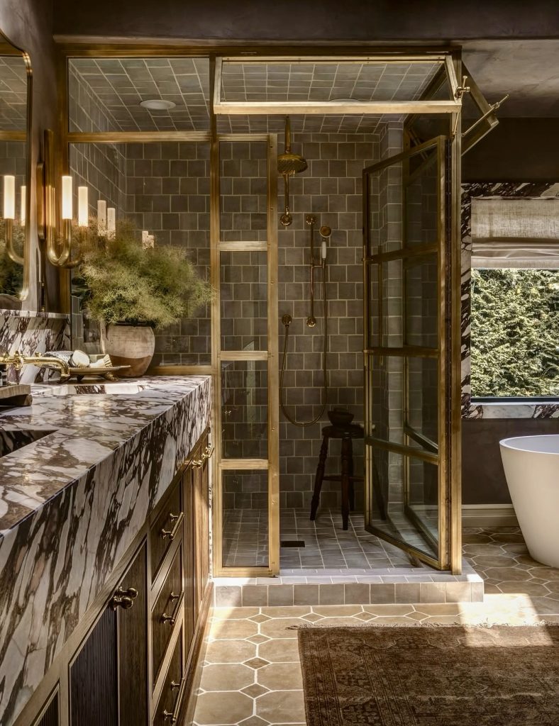 Bathroom with marble countertop and gold trim