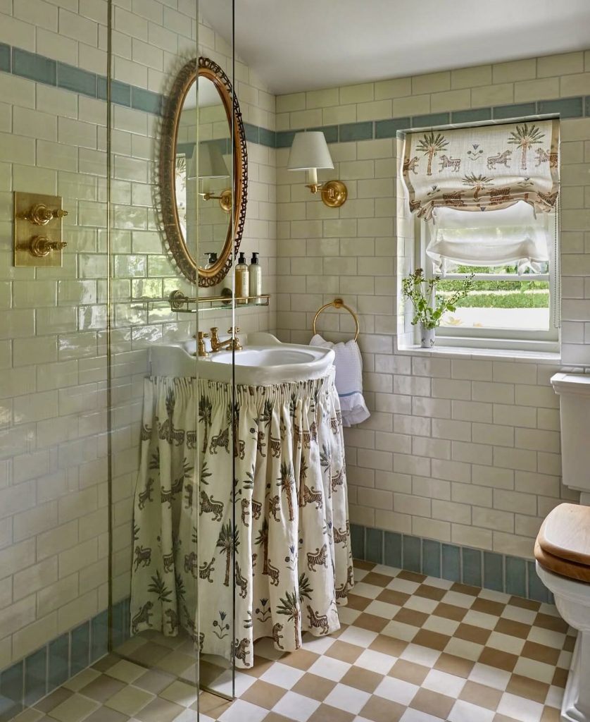 Bathroom with checkered floor and patterned sink skirt