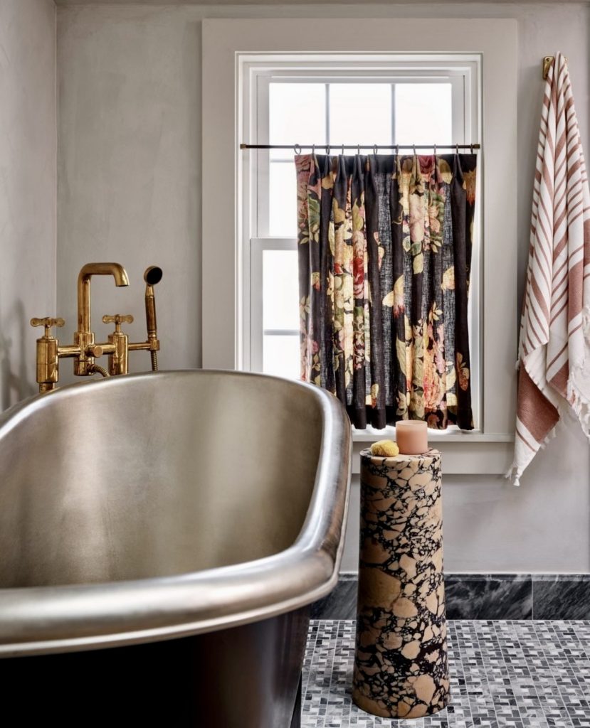 Bathroom with vintage tub and floral curtains