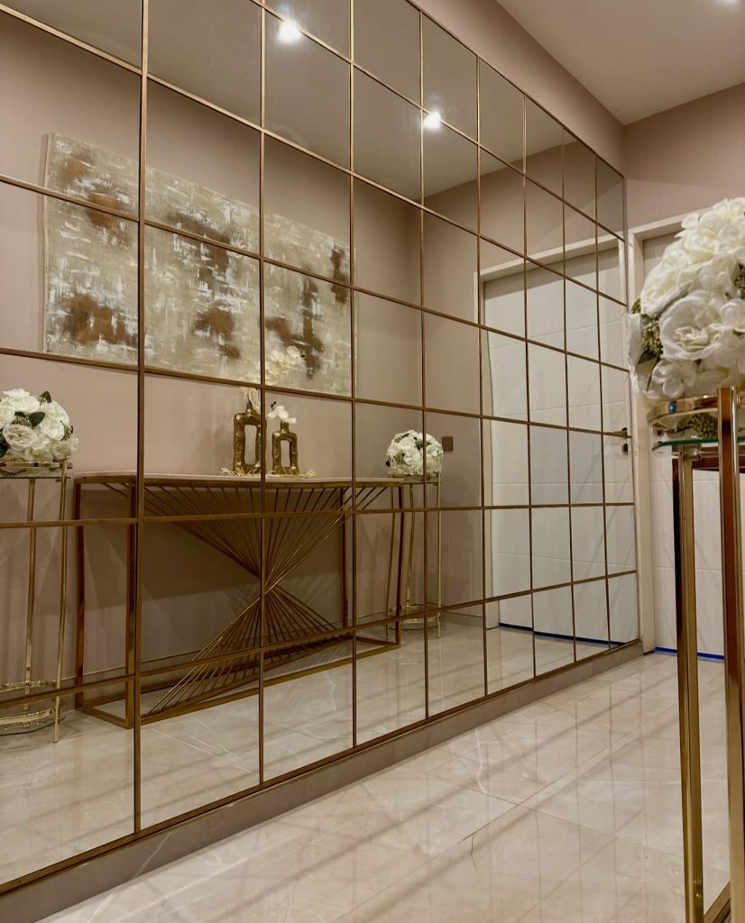 Gold-Grid Mirror Wall in Soft-Toned Hallway