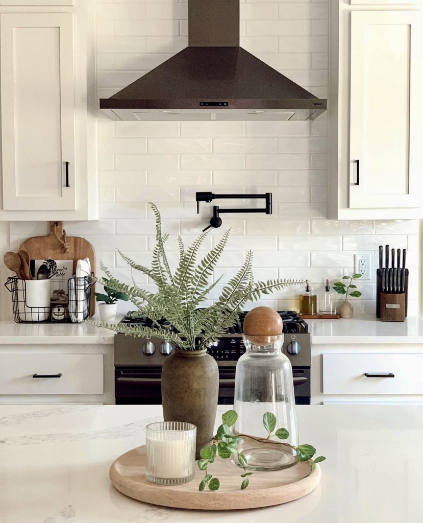 Fresh white kitchen with greenery