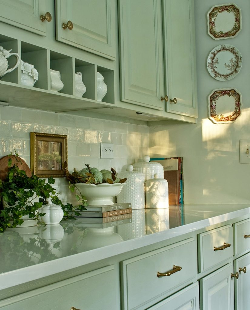 Soft sage cabinetry with vintage and organic elements