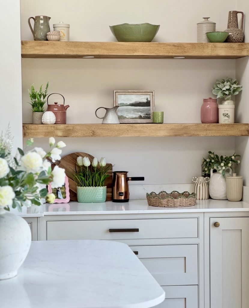 Cottage kitchen with pastel ceramics and greenery