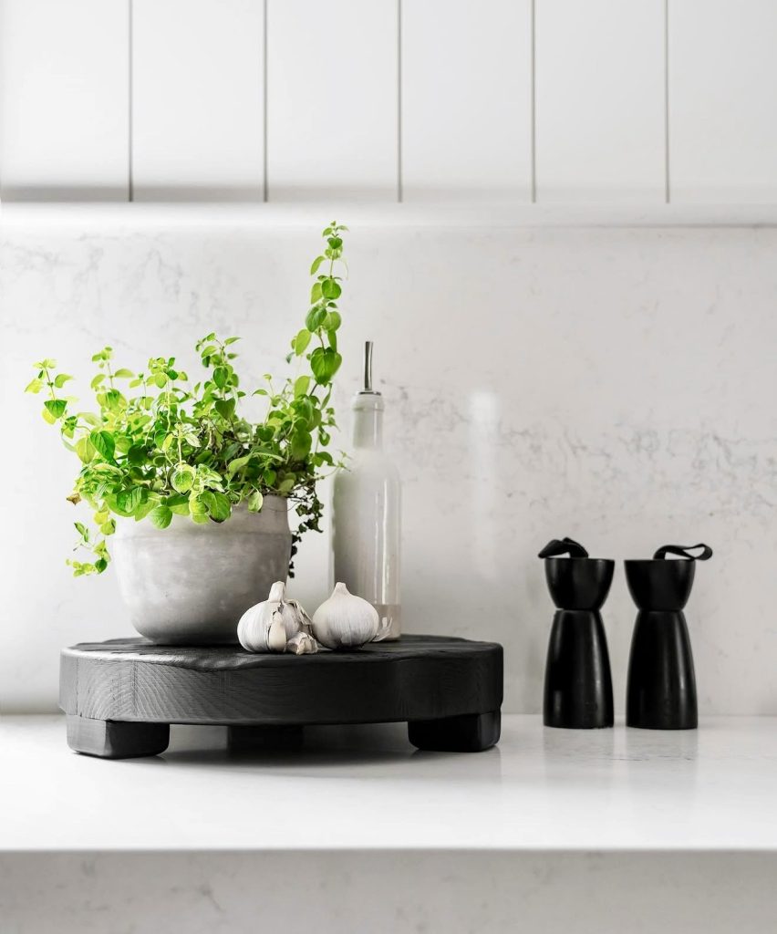 Modern kitchen with black accents and greenery