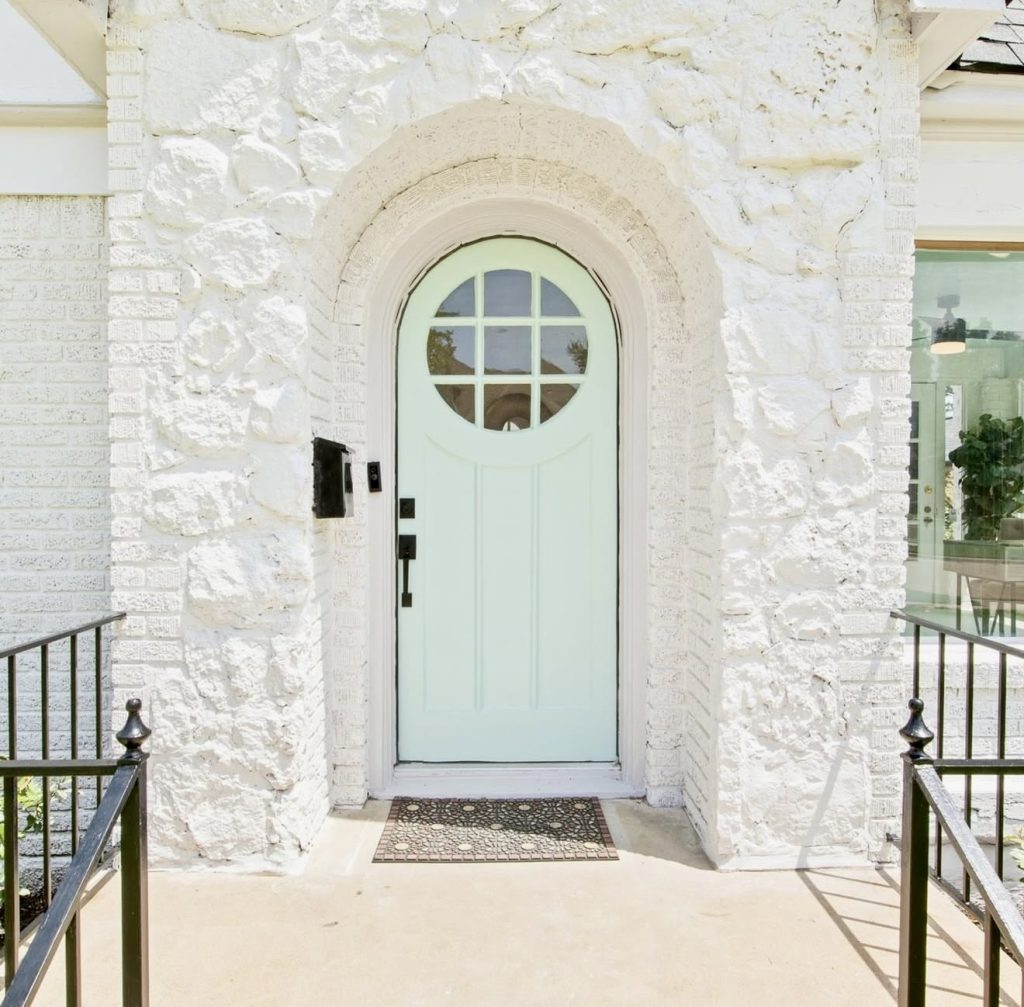 Mint Blue Door on Textured Stone Exterior