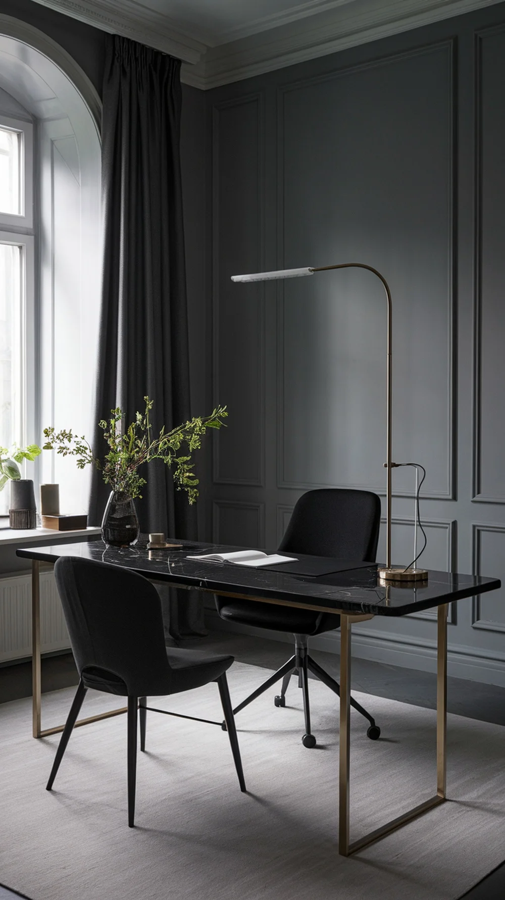 A modern home office featuring a sleek black marble desktop, stylish black chairs, and elegant decor.