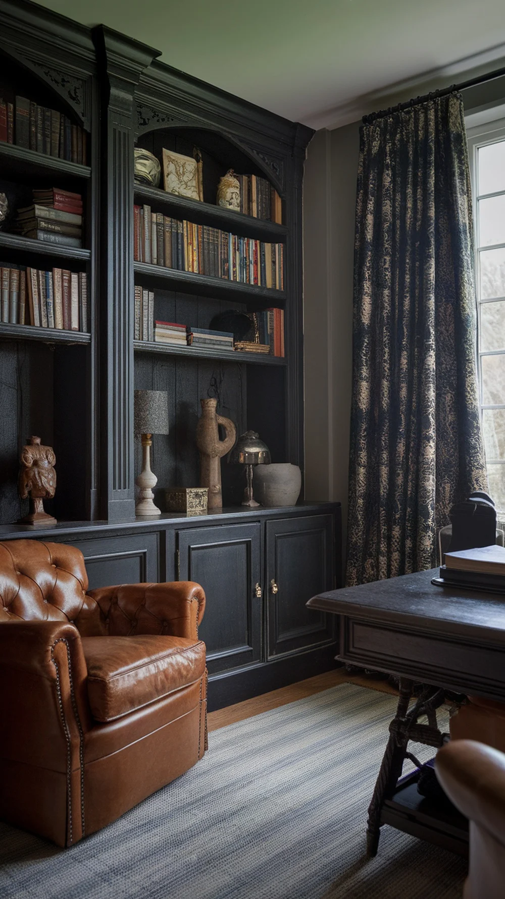 A cozy home office featuring a dark stained wood bookshelf, a brown leather chair, and decorative items.