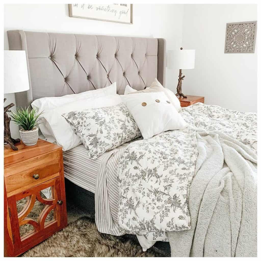 Mirrored Nightstands Flanking a Stylish Gray Headboard