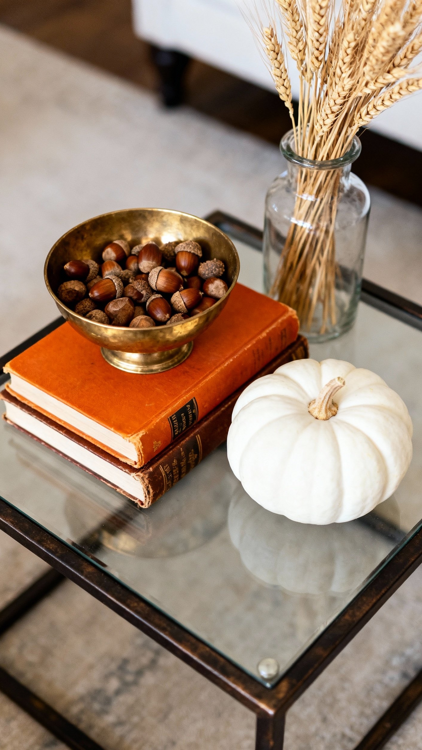 living room modern fall decor ideas - Refined Fall Decor: Metal and Glass Coffee Table Styling - Coffee table with pumpkins and wheat