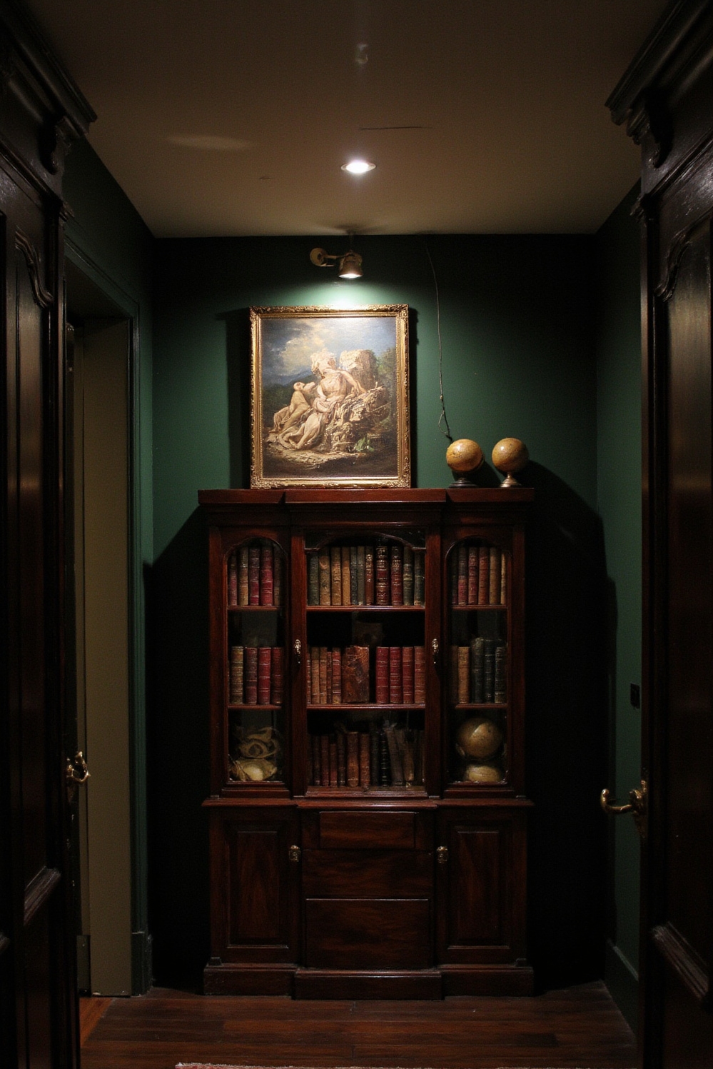 end of hallway decor - Dark Academia Hallway - Forest green walls with mahogany bookcase and brass lighting...