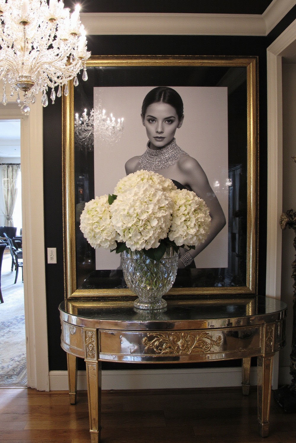 end of hallway decor - Hollywood Regency - Mirrored console, crystal chandelier, gold accents...