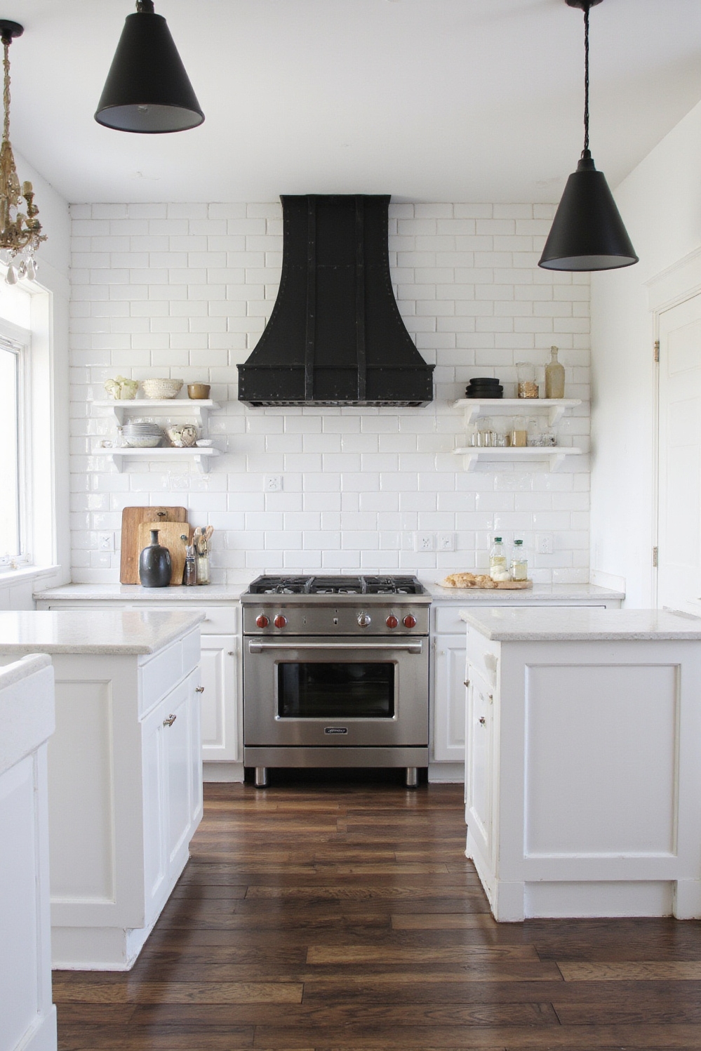 Industrial kitchen design - Refined Industrial Kitchens - White subway tiles and black steel range hood