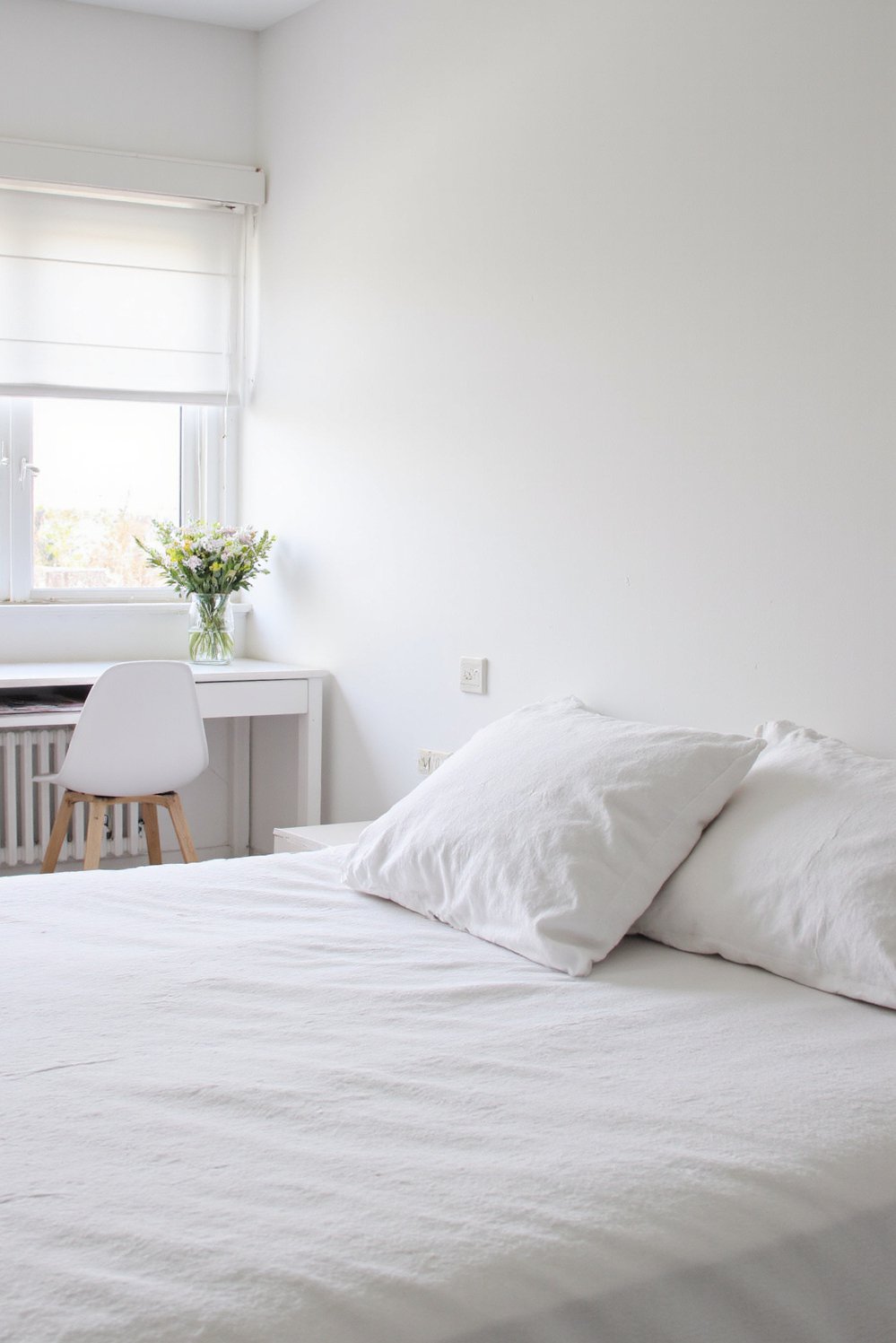 White bedroom decor ideas - Scandinavian-Inspired White Bedroom: Bright and Functional - Minimalist white bedroom with natural light