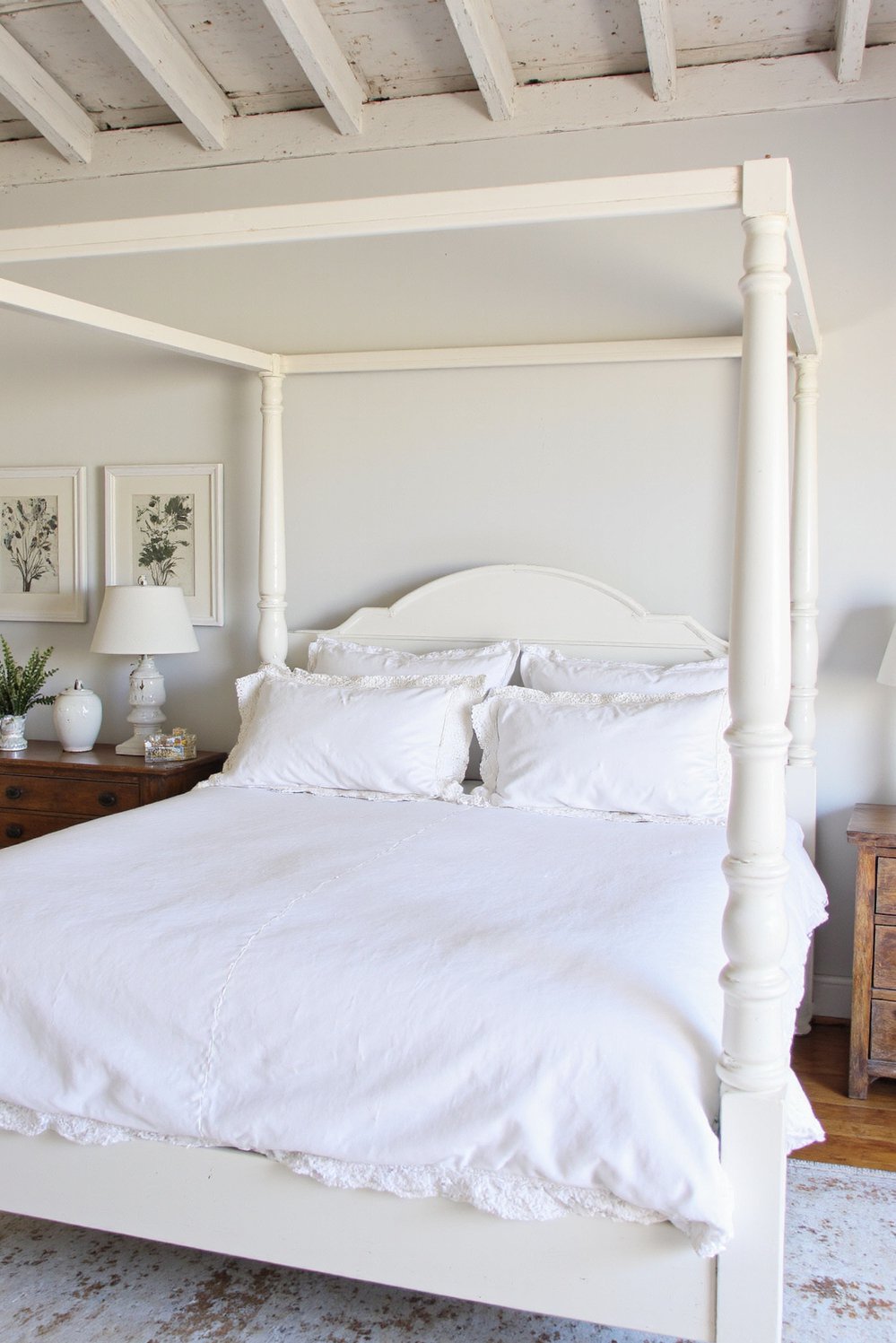 White bedroom decor ideas - Rustic Elegance: Whitewashed Charm in Bedroom Design - Cozy white bedroom with rustic wood beams