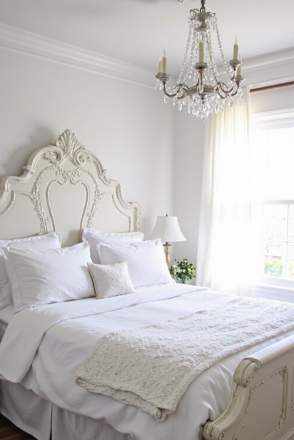 White bedroom decor ideas - Classic White Bedroom: Ornate and Timeless Appeal - Elegant white bedroom with carved wooden bed