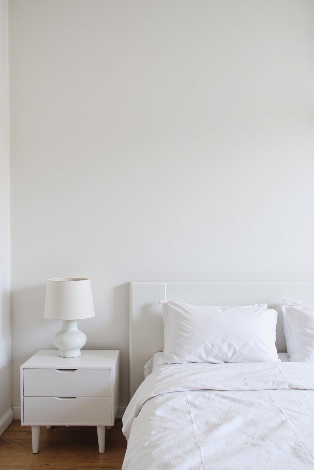 White bedroom decor ideas - All-White Bedroom: Minimalist and Streamlined - Sleek minimalist white bedroom with clean lines