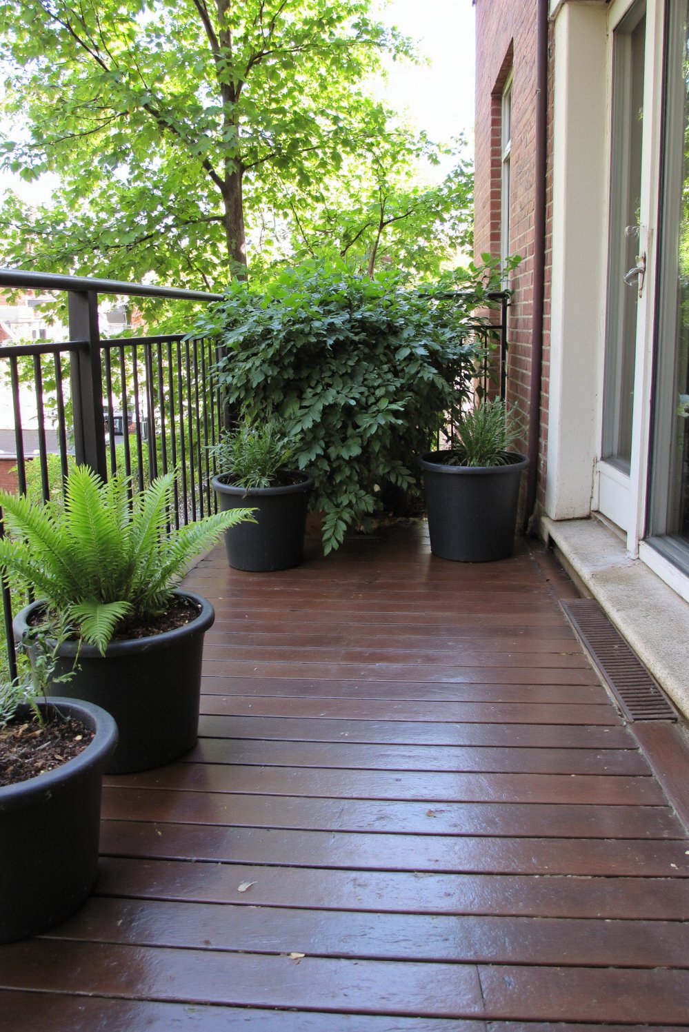 Balcony flooring ideas - Luxurious Retreat: Dark Stained Wood Flooring for a Tranquil Balcony - Use dark ipe wood flooring for a cozy balcony oasis...