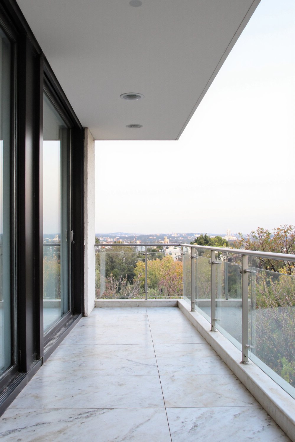 Balcony flooring ideas - Luxurious Modernity: Marble-Effect Porcelain Tiles for Chic Balconies - Use marble-look porcelain tiles for a stylish balcony...