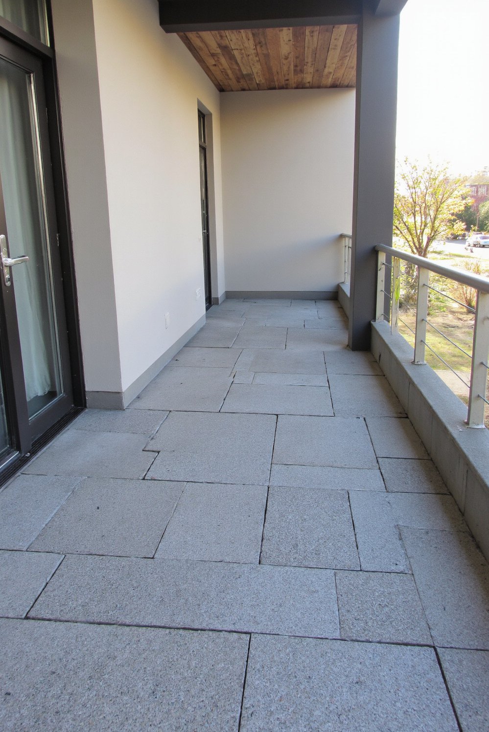 Balcony flooring ideas - Contemporary Edge: Grey Pavers for Sleek Balcony Floors - Use grey pavers for a modern balcony makeover...