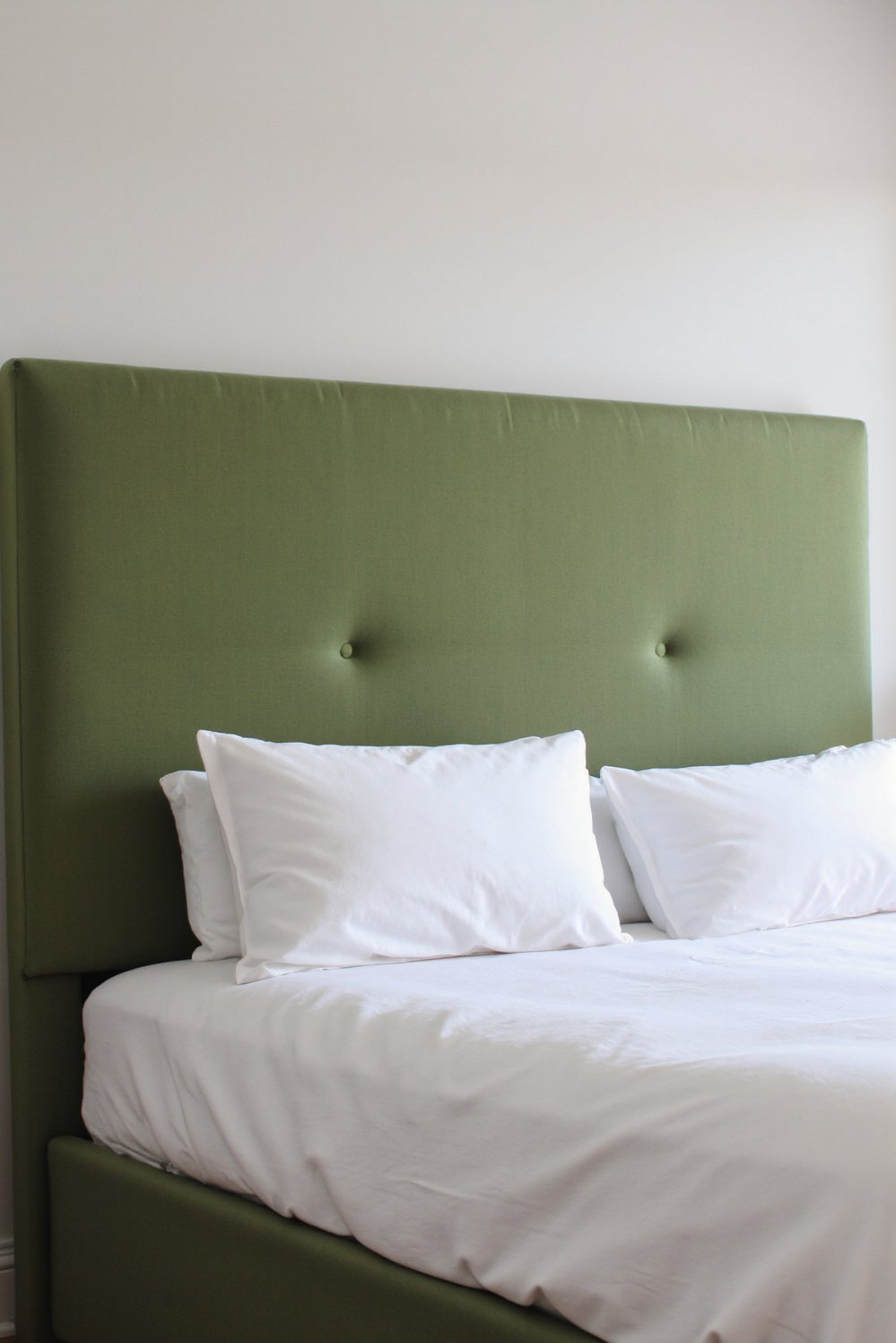 green bedroom ideas - Minimalist Sage Green Bedroom: Statement Headboard and Clean Lines - Create a sophisticated green bedroom with a statement...