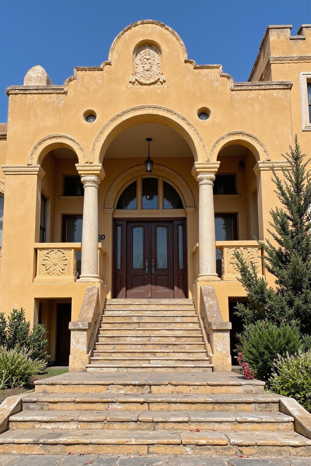 Italian villas exteriors - Grand Spanish Villa: Ornate Entryway and Detailed Carvings - Spanish villa with dramatic columns…
