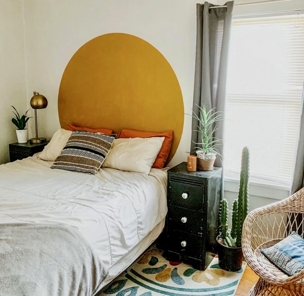 Bold painted accent wall behind platform bed