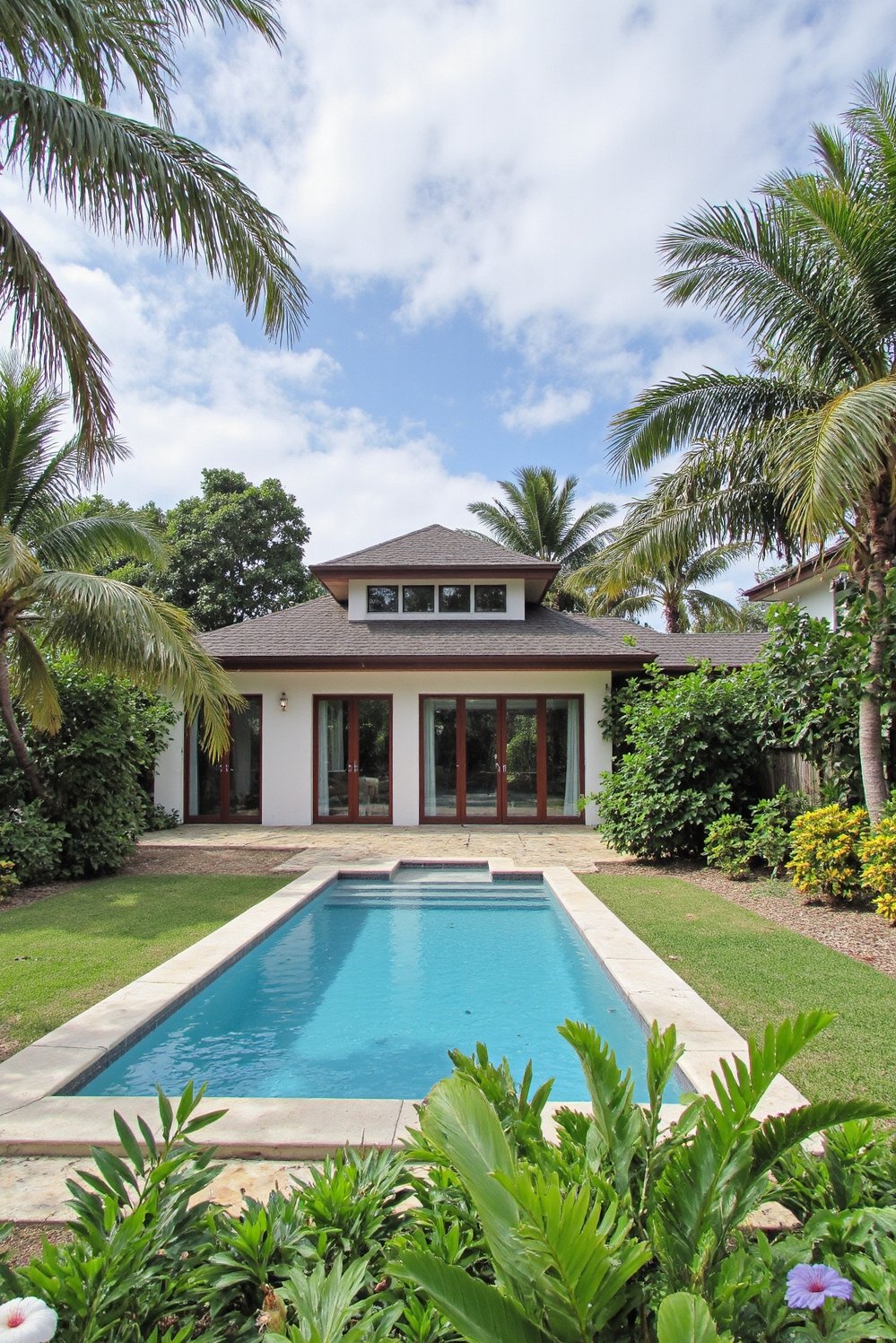 tropical house design ideas - Contemporary Tropical Homes: Embracing Nature with Garden and Pool Views