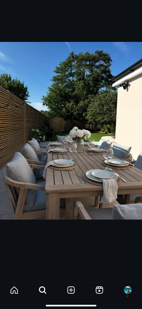 Narrow slatted fence with dining area