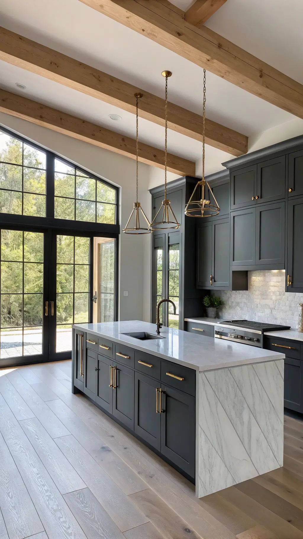 Contemporary kitchen featuring matte charcoal cabinets, white quartz waterfall island, brass pendant lighting, and marble herringbone backsplash. Sunlight filters through expansive windows, illuminating exposed wooden beams and wide-plank oak flooring. Warm LED under-cabinet lights enhance the inviting ambiance.