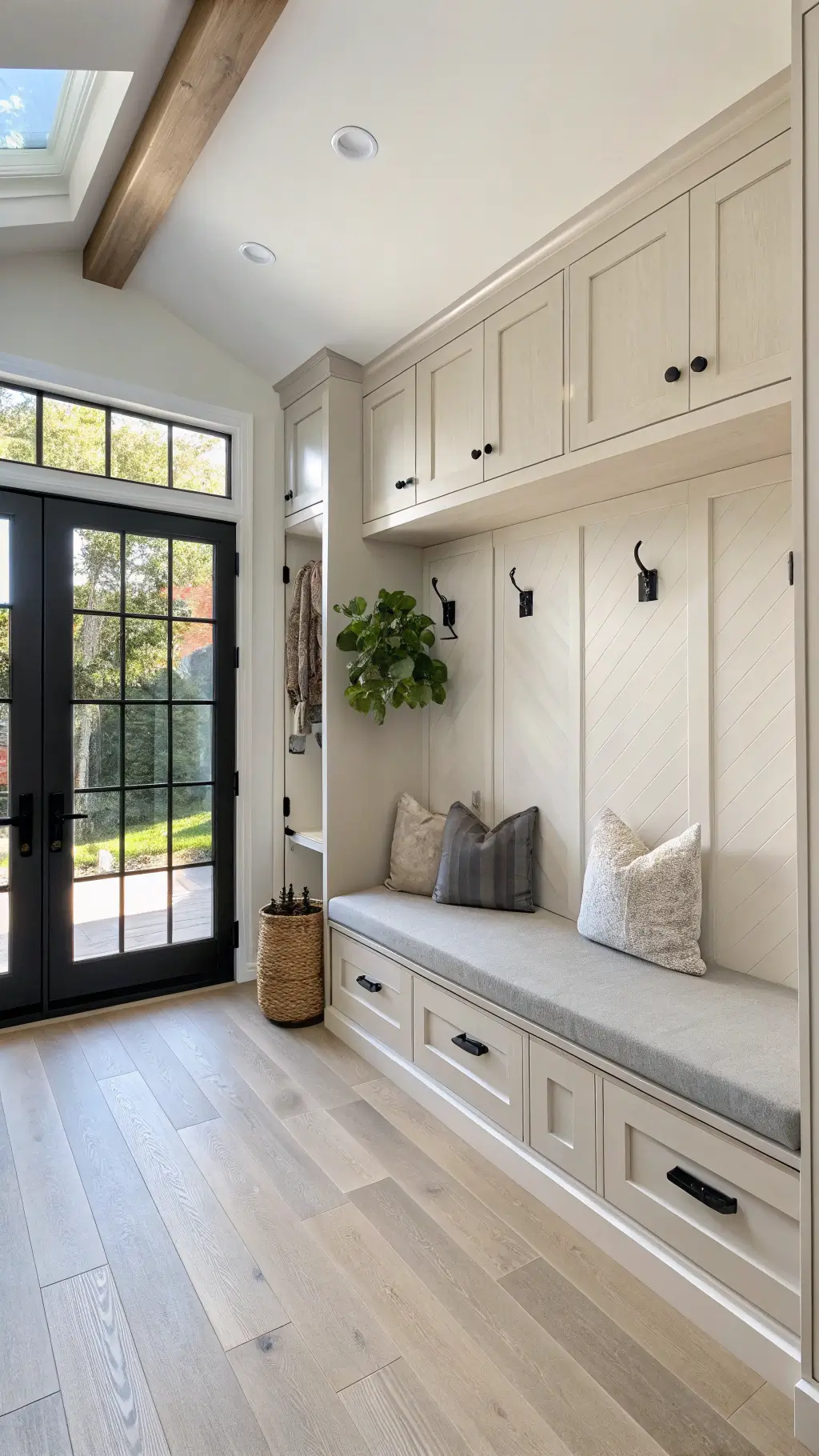 Modern minimalist mudroom with white oak cabinets, floating concrete bench, and natural light through frosted glass door during golden hour.